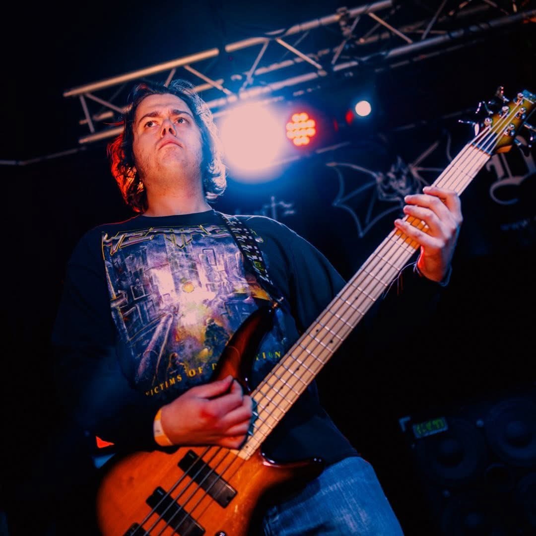 Marcus playing bass guitar live on stage
